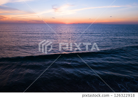 Aerial view sunset sky,Nature beautiful light sunset or sunrise over sea,Colorful dramatic majestic scenery sunset Sky with Amazing clouds and waves texture colorful sky cloud background 126322918