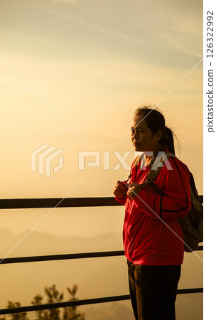 Woman traveler with backpack hiking outdoor travel lifestyle and adventure concept. cap backpack and join of tourist for green mountain tour, beauty of nature and expansive sky people of tourism Woman traveler with backpack hiking outdoor travel lifestyle and adventure concept. cap backpack and join of tourist for green mountain tour, beauty of nature and expansive sky people of tourism 126322992