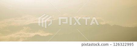 Mountain landscape. foggy morning. High angle view of trees in forest during foggy weather. Beautiful mountain and cloud natural landscape at sunrise in Thailand. panoramic banner with copy space. 126322995