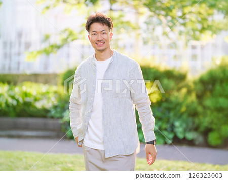 A man in his 30s relaxing in the park Male portrait 126323003
