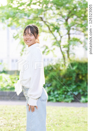 Portrait of a young woman relaxing in the park 126323005