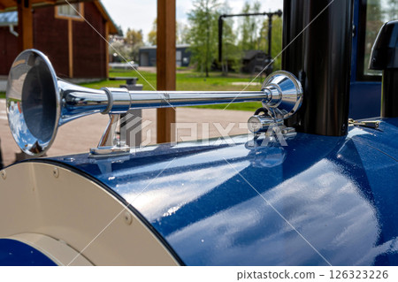 Close-up of the vintage horn on a blue car in the park Close-up of the vintage horn on a blue car in the park 126323226
