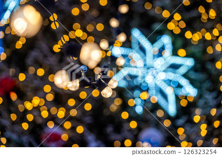 Christmas tree with yellow garlands lights and bokeh copy space Christmas tree with yellow garlands lights and bokeh copy space 126323254