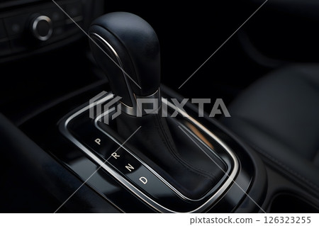 Closeup of modern automatic car gear shift lever with leather and chrome finish 126323255