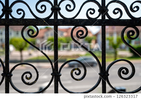 Detail of a wrought iron fence on a street in the city. Selective focus. 126323317