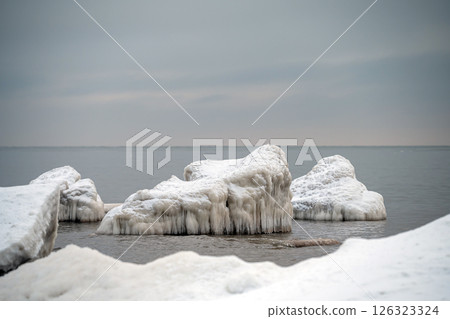 Close-up shot of the Frozen ice blocks in Baltic sea water on the shore, Kaltene, Latvia Close-up shot of the Frozen ice blocks in Baltic sea water on the shore, Kaltene, Latvia 126323324