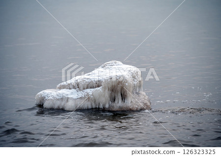 Close-up shot of the Frozen ice blocks in Baltic sea water on the shore, Kaltene, Latvia 126323325