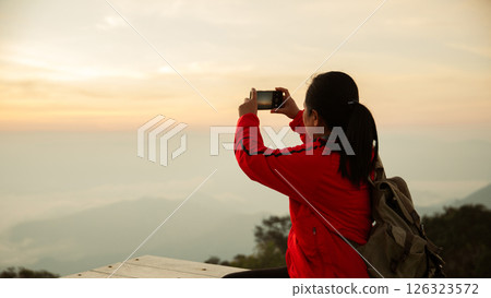 Woman traveler with backpack hiking outdoor travel lifestyle and adventure concept. cap backpack and join of tourist for green mountain tour, beauty of nature and expansive sky people of tourism Woman traveler with backpack hiking outdoor travel lifestyle and adventure concept. cap backpack and join of tourist for green mountain tour, beauty of nature and expansive sky people of tourism 126323572