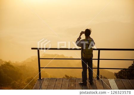 Man traveler with camera backpack hiking outdoor travel lifestyle and adventure concept. cap backpack and join of tourist for green mountain tour, beauty of nature and expansive sky people of tourism 126323578