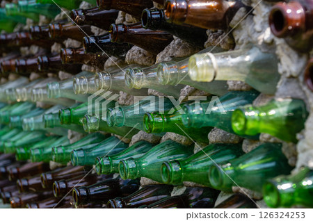 Wine bottles in a row on a stone wall. Close-up 126324253