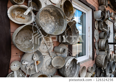 The pan house (puodu namas) is covered with pots and pans of all shapes and sizes, closeup view The pan house (puodu namas) is covered with pots and pans of all shapes and sizes, closeup view 126324256