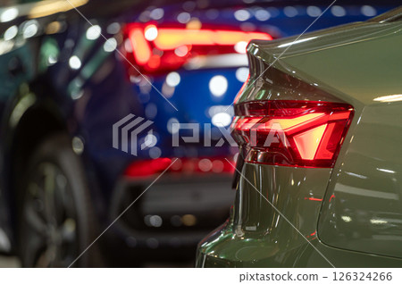 The rear lights shine brightly in the dark. bokeh light background. The rear lights shine brightly in the dark. bokeh light background. 126324266