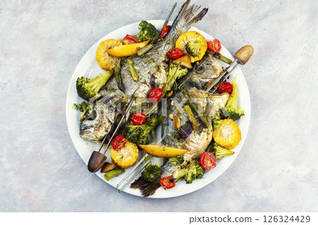 Baked dorado fish with asparagus and vegetables. Baked dorado fish with asparagus and vegetables. 126324429