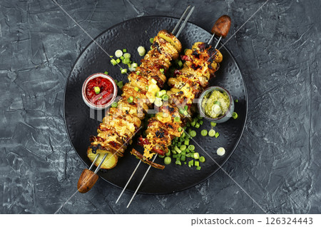 Potatoes with bacon on skewers, summer barbecue. Potatoes with bacon on skewers, summer barbecue. 126324443