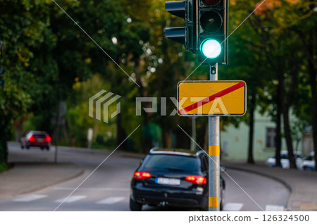 traffic semaphore with green light on defocused background of autumn city, closeup 126324500