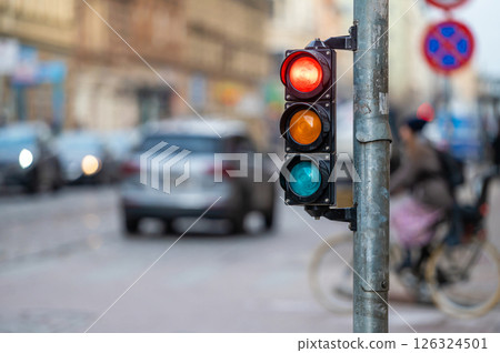traffic light on the street junction with beautiful bokeh, city with cars in the background 126324501