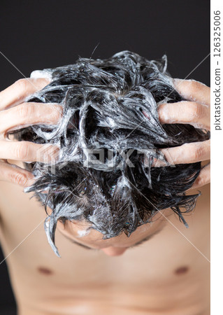 Middle-aged man shampooing 126325006