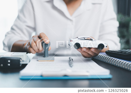 Businesswoman hand stamp approve on financial business approval document paper. Man hand accept permit contract agreement. Broker manager sign contract bank guarantee approved stamp application form 126325026