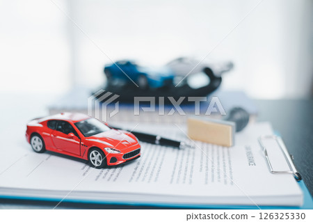 Approved car loan application with car key, rubber stamp and calculator concept. financial document on wooden table. Asset approval purchases to buy car. Ideas for car buying checklist loan tax 126325330