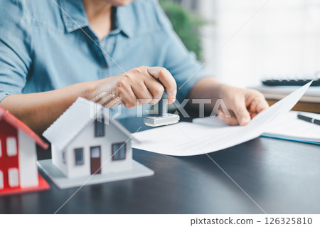 Businesswoman hand stamp approve on financial business approval document paper. Man hand accept permit contract agreement. Broker manager sign contract bank guarantee approved stamp application form Businesswoman hand stamp approve on financial business approval document paper. Man hand accept permit contract agreement. Broker manager sign contract bank guarantee approved stamp application form 126325810