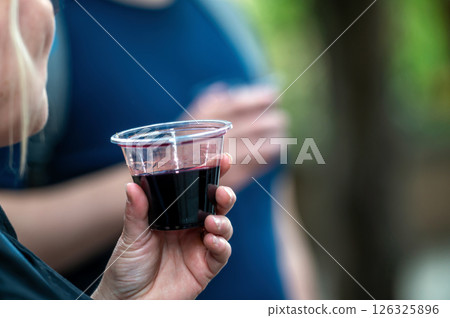 Enjoying Red Wine During a Summer Gathering at a Local Vineyard With Friends Enjoying Red Wine During a Summer Gathering at a Local Vineyard With Friends 126325896