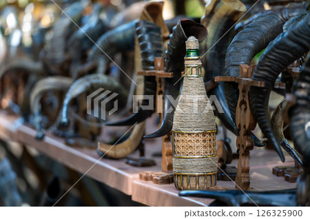 Artisan Display of Intricate Horn Sculptures and Woven Bottle at Outdoor Market Event Artisan Display of Intricate Horn Sculptures and Woven Bottle at Outdoor Market Event 126325900