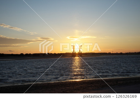 The sun setting over the torii gate as seen from the sandy beach of Bentenjima Beach 126326169