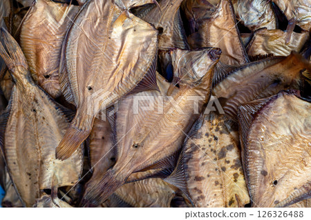 Dried fish on display at a lively market, highlighting local seafood preservation for sale. 126326488