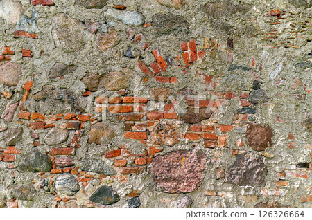 A textured wall made of stones and bricks reveals layers of history in a rustic setting A textured wall made of stones and bricks reveals layers of history in a rustic setting 126326664
