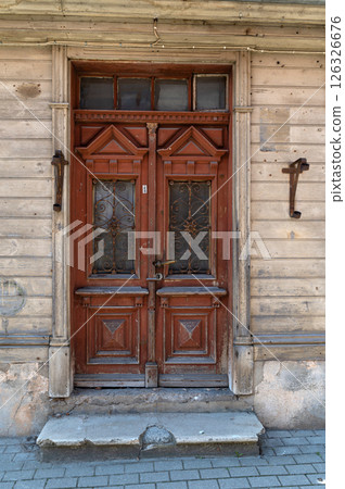 Beautifully carved wooden double doors of an old building in a historic district on a sunny day 126326676