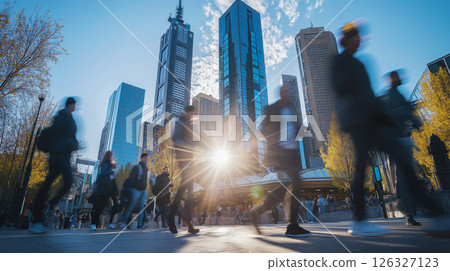 Blurry Figures in a Lively City Center with Skyscrapers and a Stunning Sunlit Background 126327123
