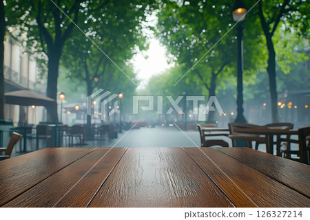 Weathered Wooden Table in a Tranquil Outdoor Cafe with Blurred Cityscape 126327214
