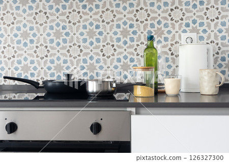 Minimalist domestic kitchen countertop with cookware and ingredients Minimalist domestic kitchen countertop with cookware and ingredients 126327300