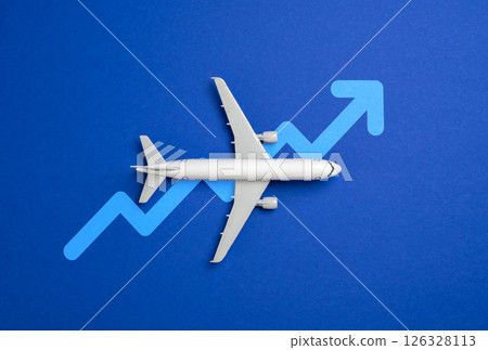 Passenger plane and arrow up. Concept of growth of flights, passenger flow. Hot season. Increase of cost of tickets, fuel, service of flight personnel. Airline industry, travel economics Passenger plane and arrow up. Concept of growth of flights, passenger flow. Hot season. Increase of cost of tickets, fuel, service of flight personnel. Airline industry, travel economics 126328113