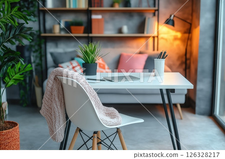 Chic home workspace in a compact studio with a sleek white desk 126328217