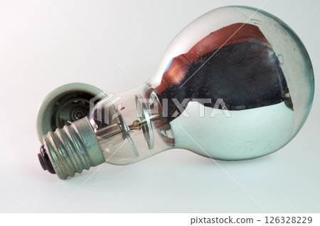 vintage high-power filament street light bulb, mirror coated reflector, near the ceramic screw socket vintage high-power filament street light bulb, mirror coated reflector, near the ceramic screw socket 126328229