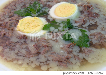 aspic with meat, eggs and fresh parsley, made with thick and rich nutritious bone broth, frozen. closeup aspic with meat, eggs and fresh parsley, made with thick and rich nutritious bone broth, frozen. closeup 126328267