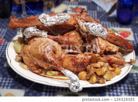 oven-roasted goose with apples, cut into chunks. celebratory dish served to the table on an elegant porcelain plate. with clipping path oven-roasted goose with apples, cut into chunks. celebratory dish served to the table on an elegant porcelain plate. with clipping path 126328385