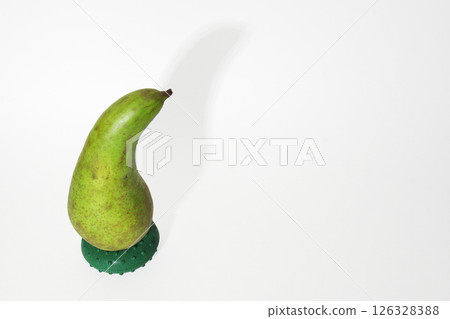 pear conference on a round stand drop shadow on white background. beautifully curved, with short stalk, green peel with gray-brown spots. with clipping path pear conference on a round stand drop shadow on white background. beautifully curved, with short stalk, green peel with gray-brown spots. with clipping path 126328388