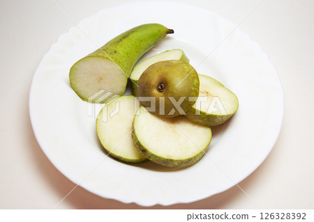 pear conference, cut into thin slices, beautifully arranged on white plate. back and front parts are bigger 126328392