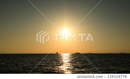 sun setting into the sea 126328776