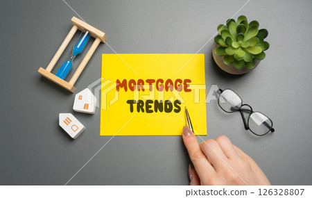 Notes with Mortgage trends concept and a miniature houses. Mortgage rates and the latest news about their changes. Housing loan and real estate. Business and finance 126328807