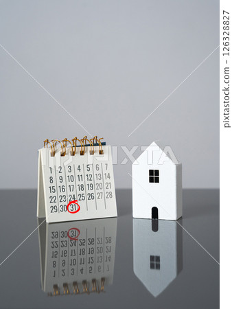 House and calendar with date marked. Last day of rent payment, tenants moving out. Deadline for property taxes. Complete rent payments, finalize leases, or pay property-related taxes. Housing cycle 126328827
