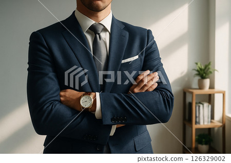 Directors suit and ID badge placed on an empty chair at a minimalist office desk with a clipboard, pen and wristwatch under soft daylight 126329002