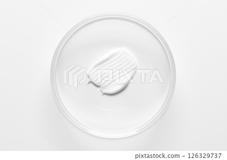 A sample of cosmetic moisturizing or anti-aging cream in a petri dish. A sample of cosmetic moisturizing or anti-aging cream in a petri dish. 126329737