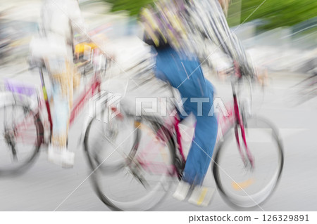Silhouettes of group colorful cyclists on the city streets, abstract, motion blur. Urban cycling event. Concept of modern lifestyle, speed, street lifestyle, for background Silhouettes of group colorful cyclists on the city streets, abstract, motion blur. Urban cycling event. Concept of modern lifestyle, speed, street lifestyle, for background 126329891