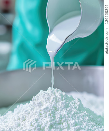 Food scientist pouring milk into cottage cheese production process 126330295