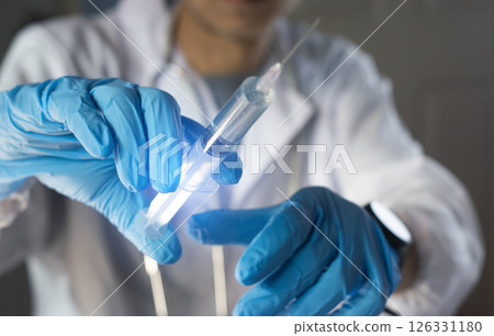 Doctors prepare syringes for vaccination Doctors prepare syringes for vaccination 126331180