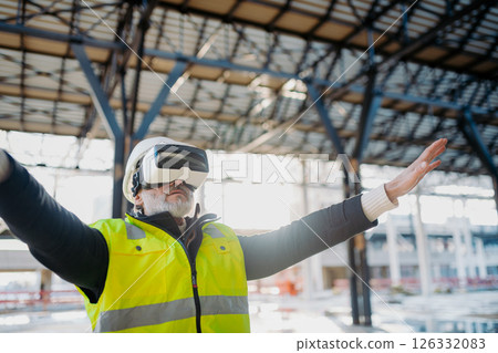Engineer using virtual reality to inspect building progress. 126332083