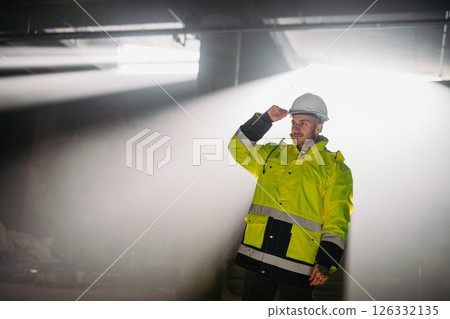 Construction workers at work on modern building site. 126332135